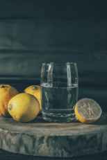 photo of drinking glass beside lemons